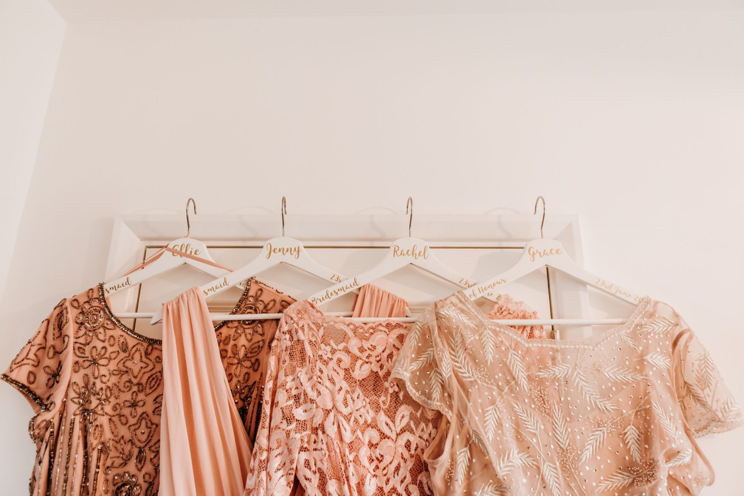 bridesmaid dresses hung on personalised hangers