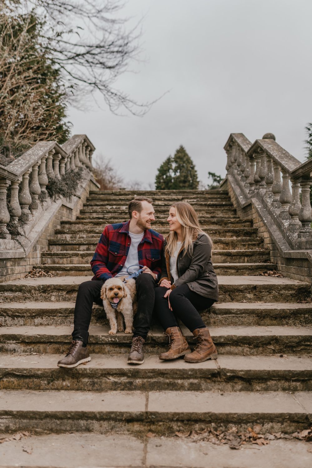 couple pose together with their dog for their kent couple shoot