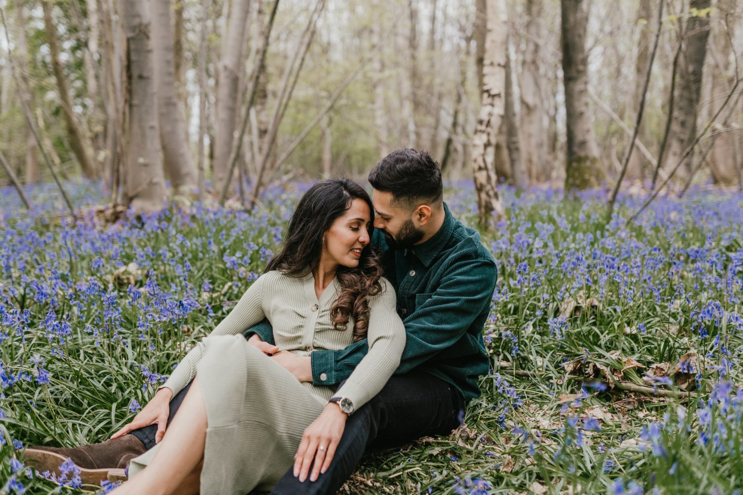 couple embracing in bluebell woods in Kent