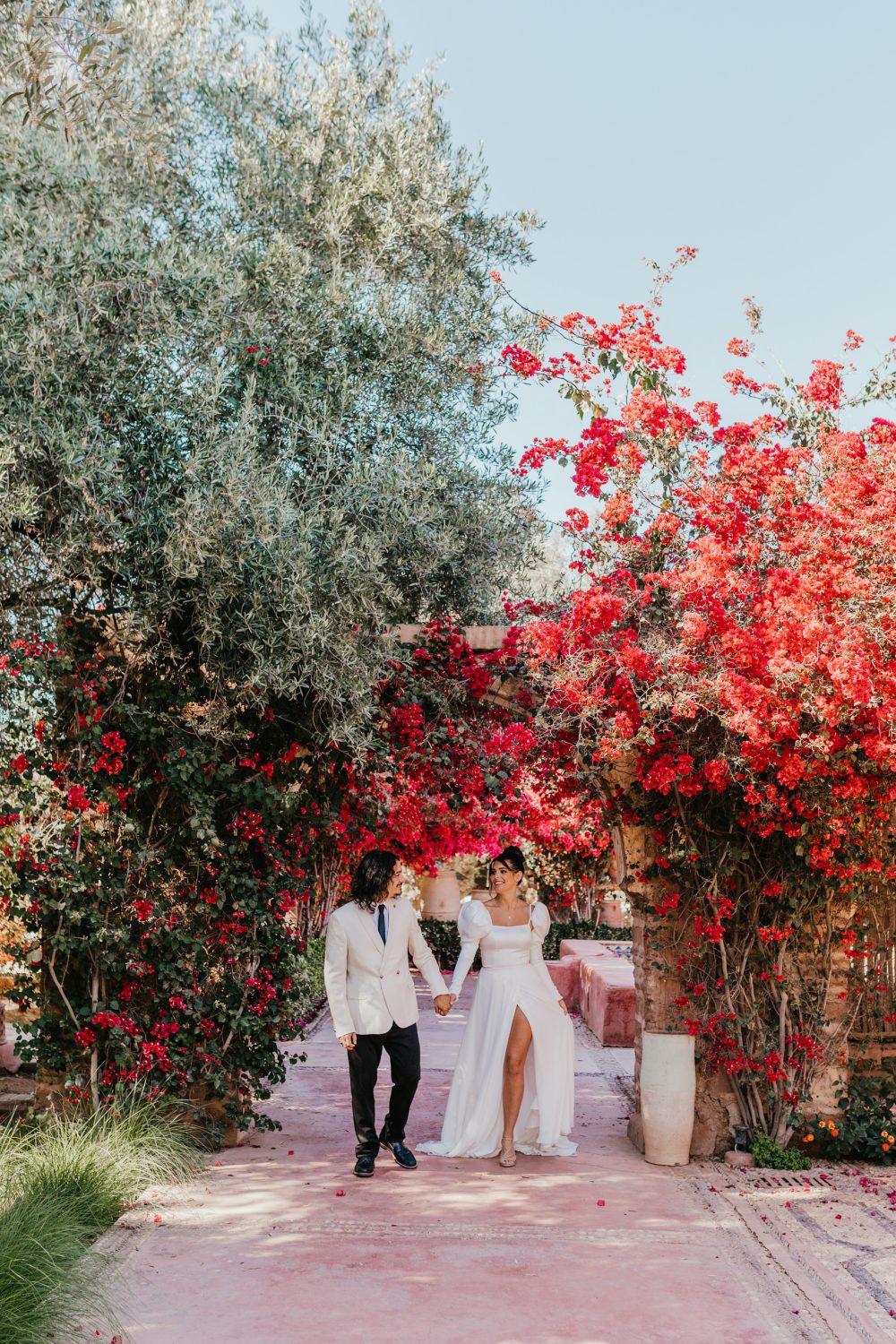 bride and groom surrounded by bougainvillea flowers at Beldi Country Club in Marrakech