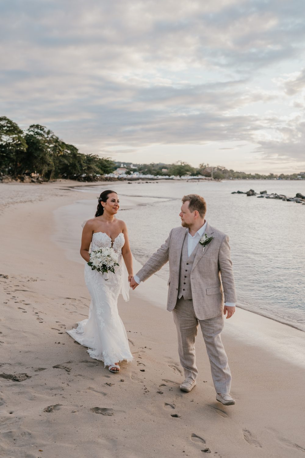 bride and groom walking on the beach in saint lucia at stolentime by rendezvous wedding venue
