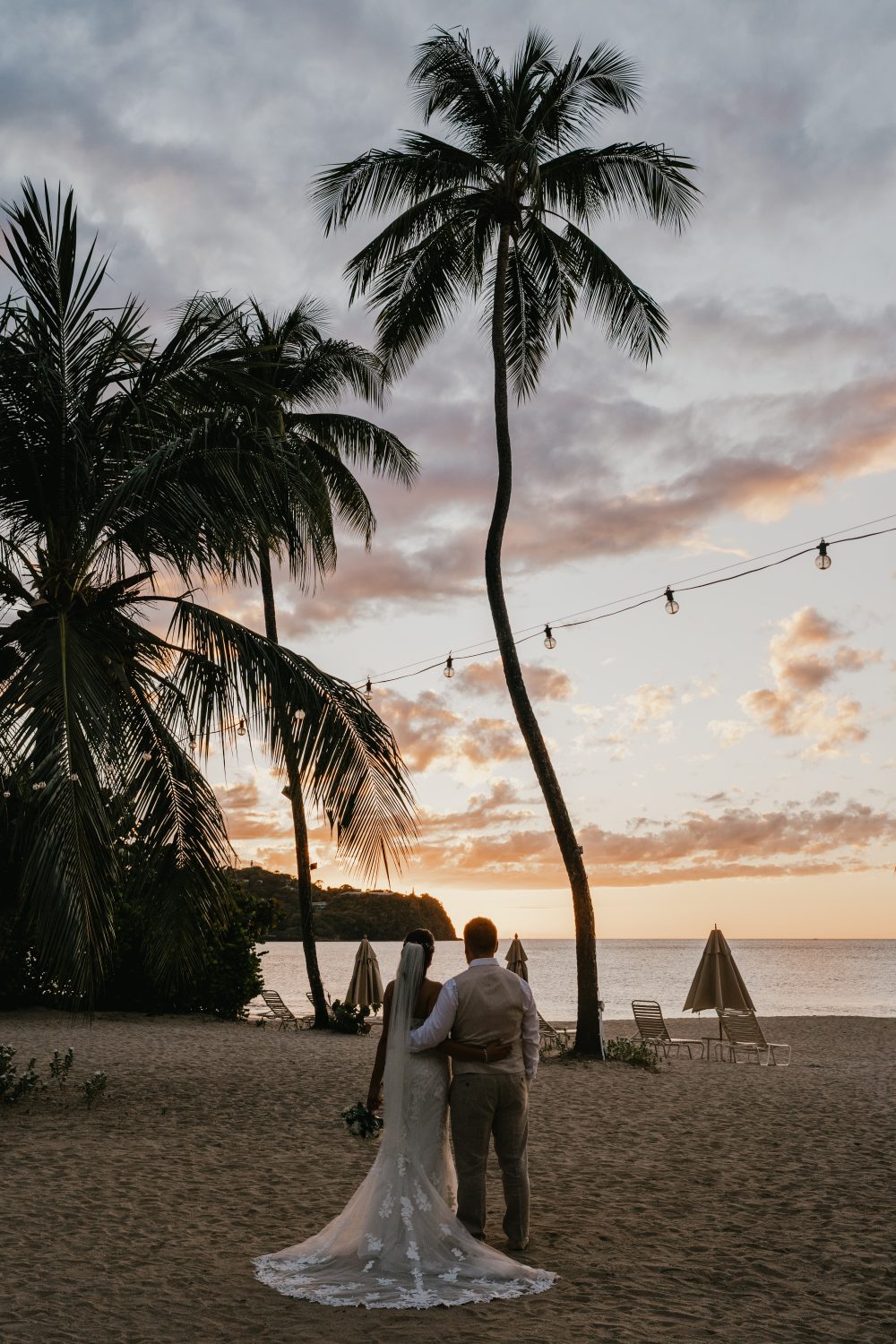 bride and groom at sunset on the beach in saint lucia at stolentime by rendezvous wedding venue