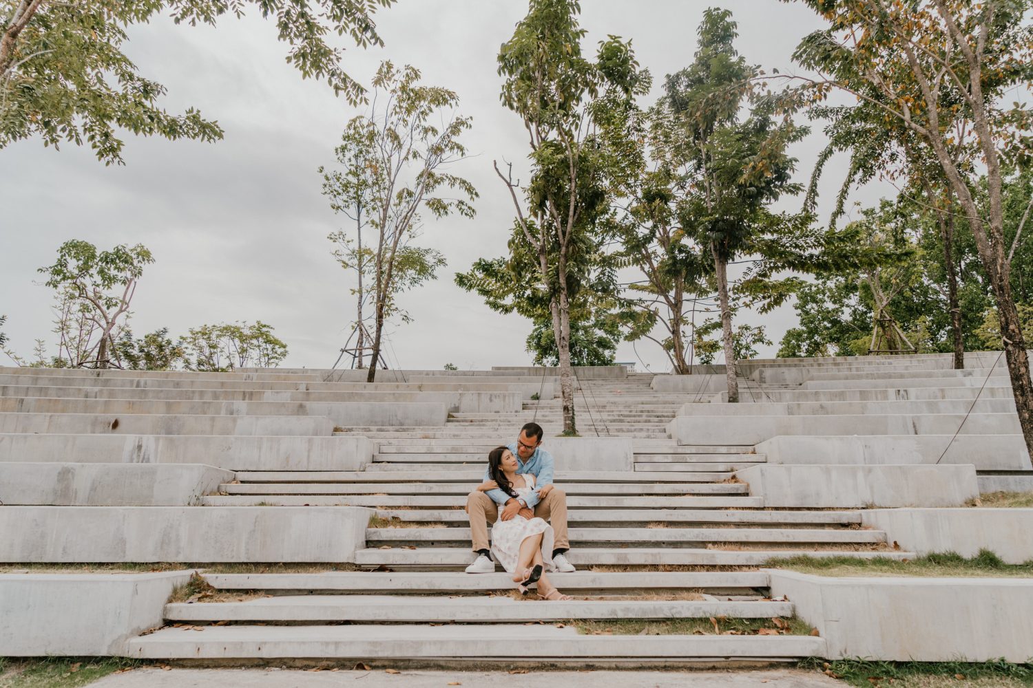 couple posing together in a bangkok park for their thailand couple shoot