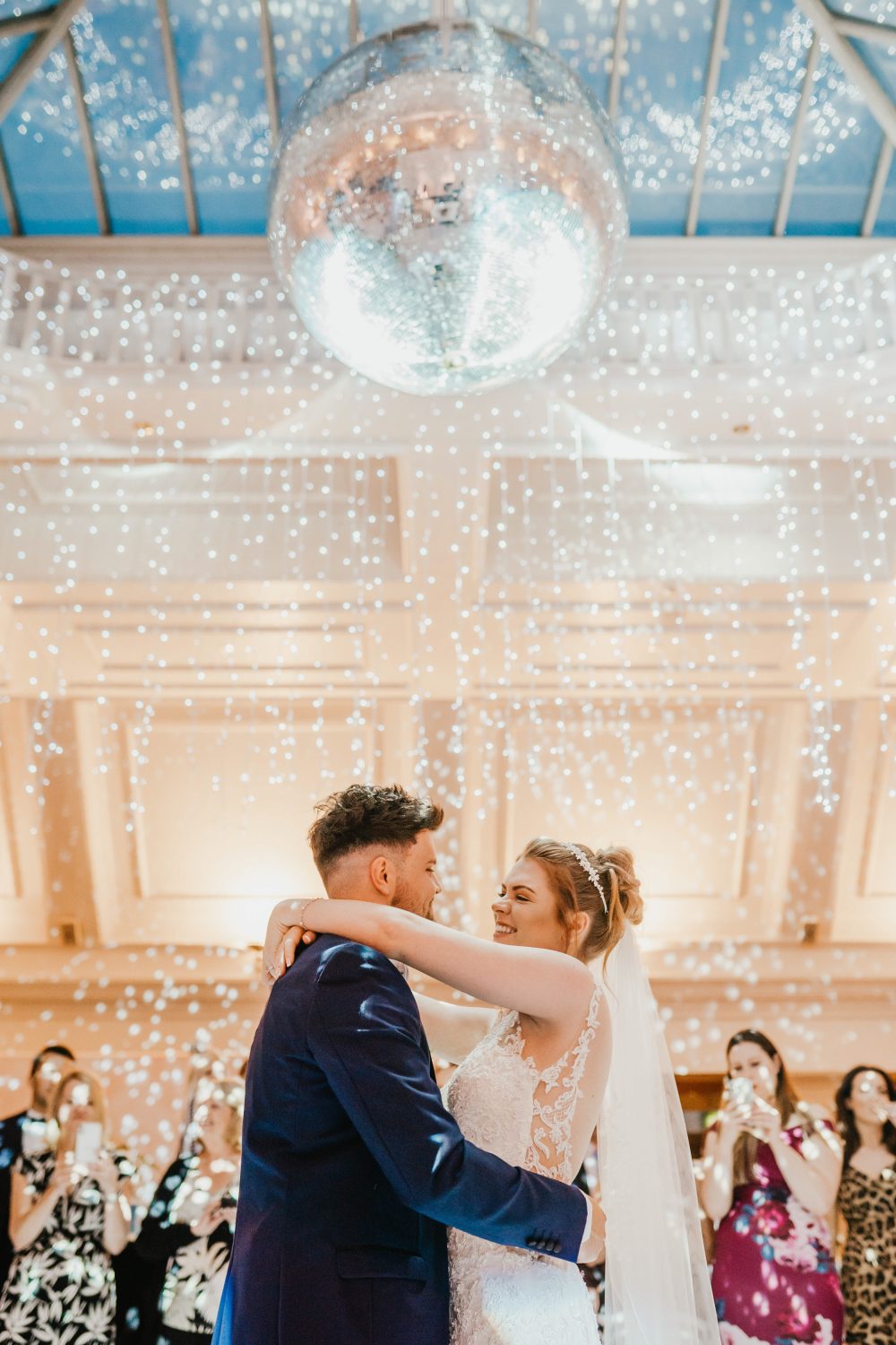 bride and groom first dance under a disco ball at stockbrook manor wedding venue in essex