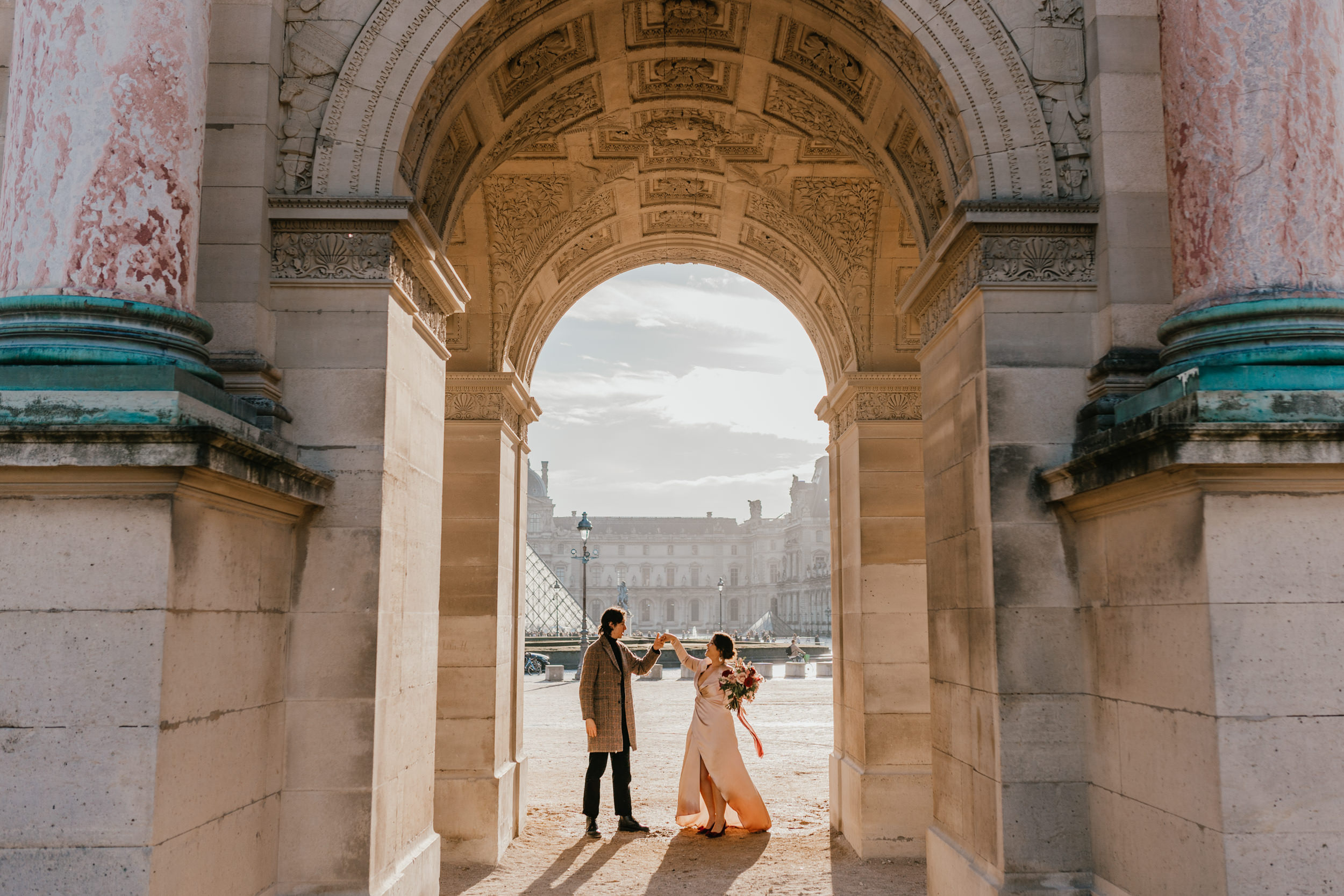 couple elopement in paris at sunrise with the louvre in the background
