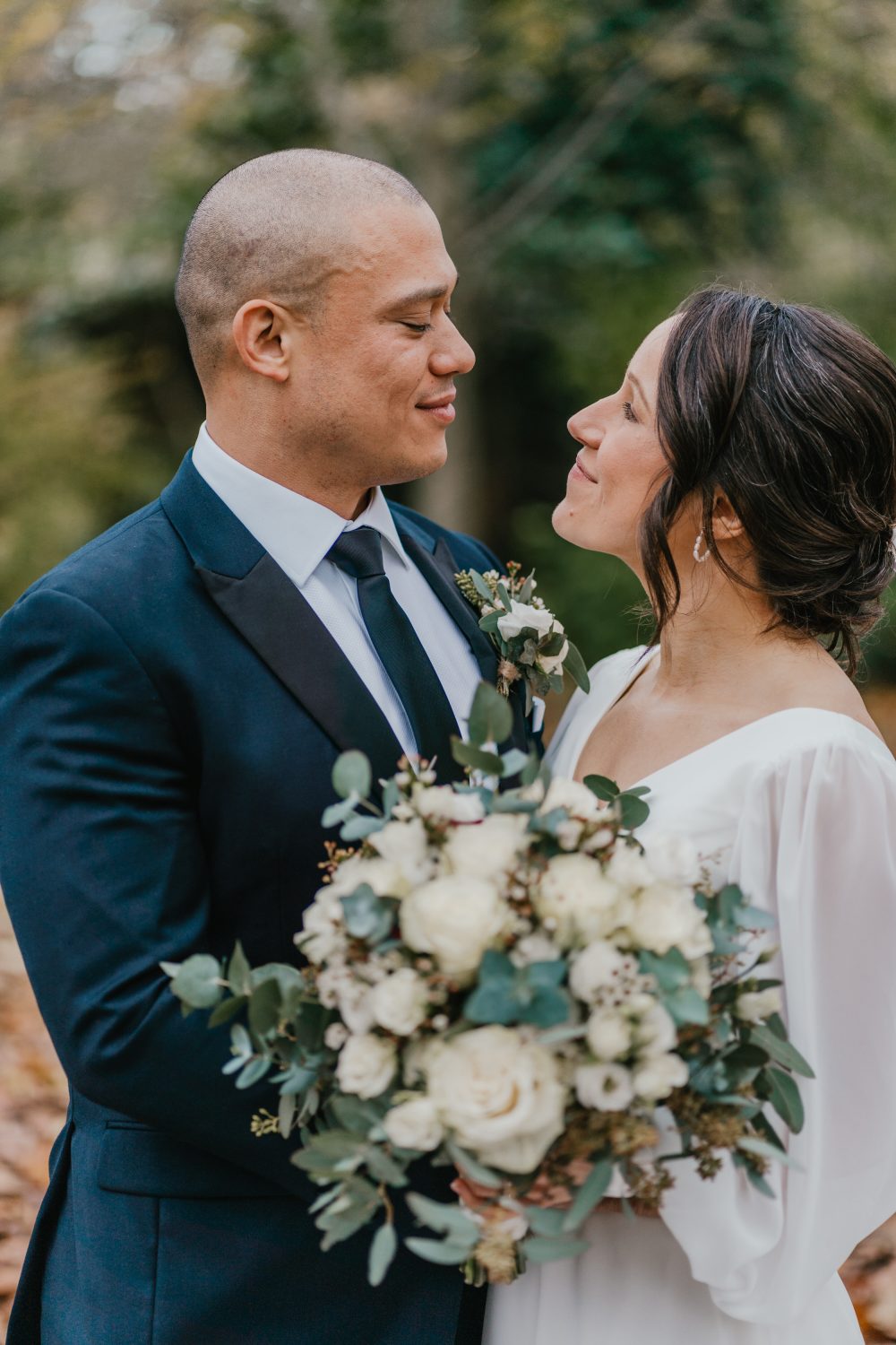bride and groom portrait on their winter wedding day with stunning white bouquet