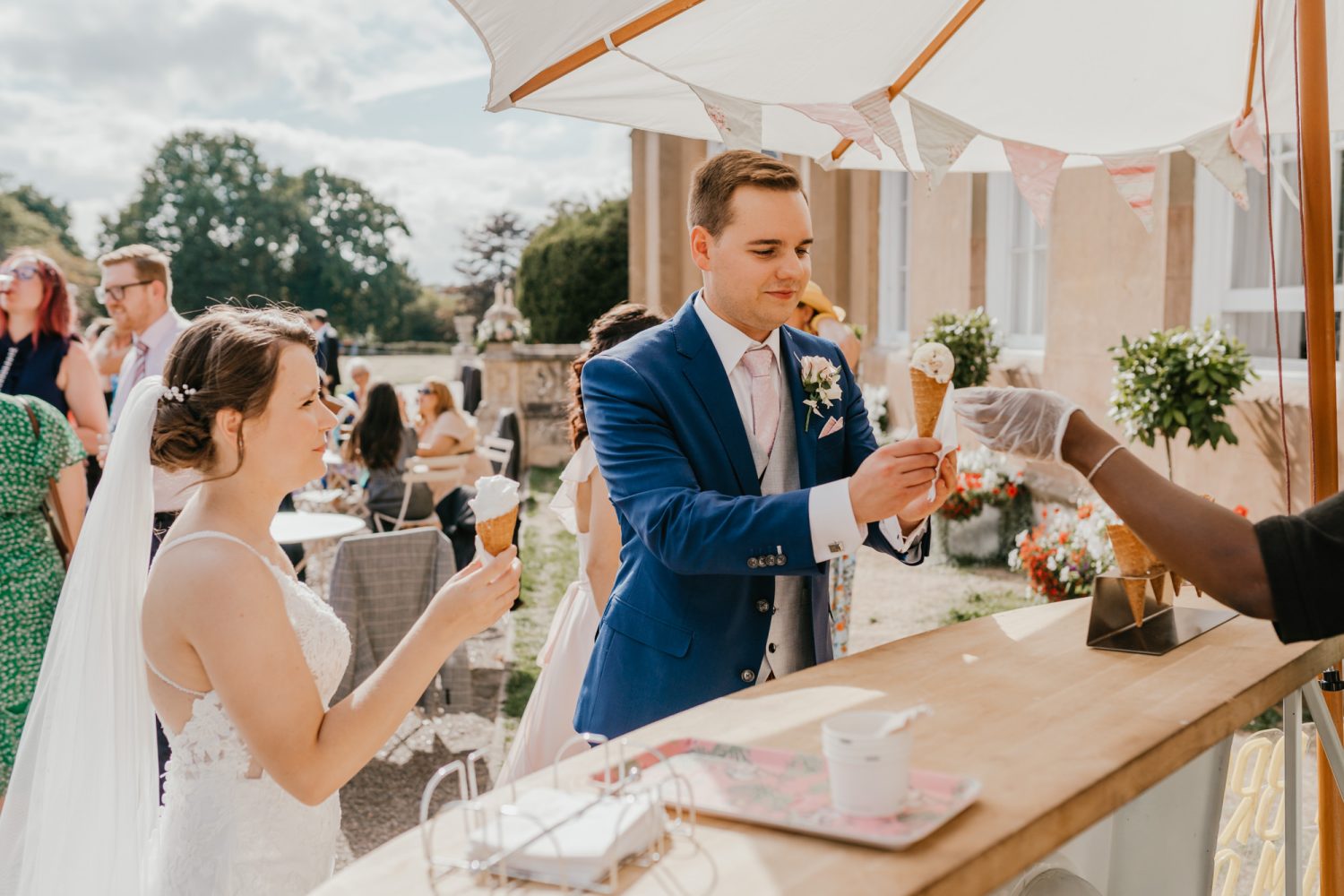 bride and groom getting ice cream at nonsuch mansion wedding venue in surrey