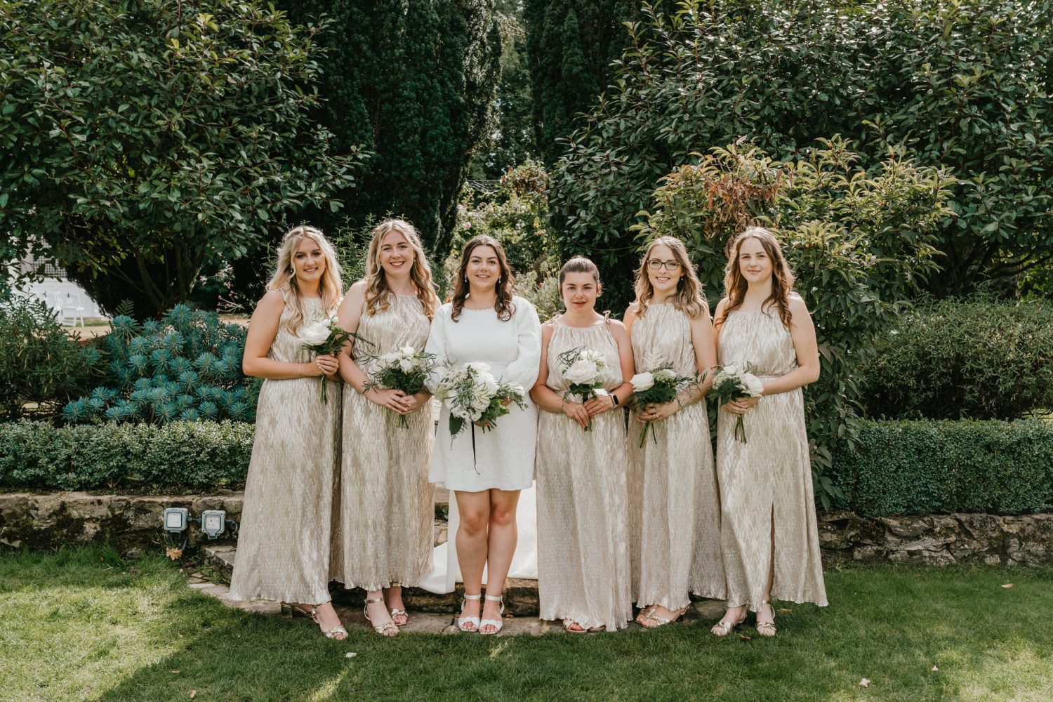 bride and bridesmaids portraits in the gardens at a wedding at hayne house in hythe