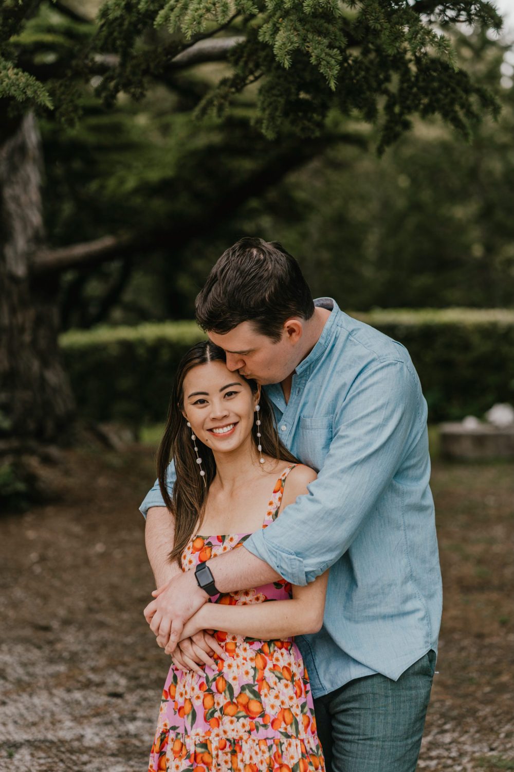 groom kissing his bride's forehead on their pisa couple shoot