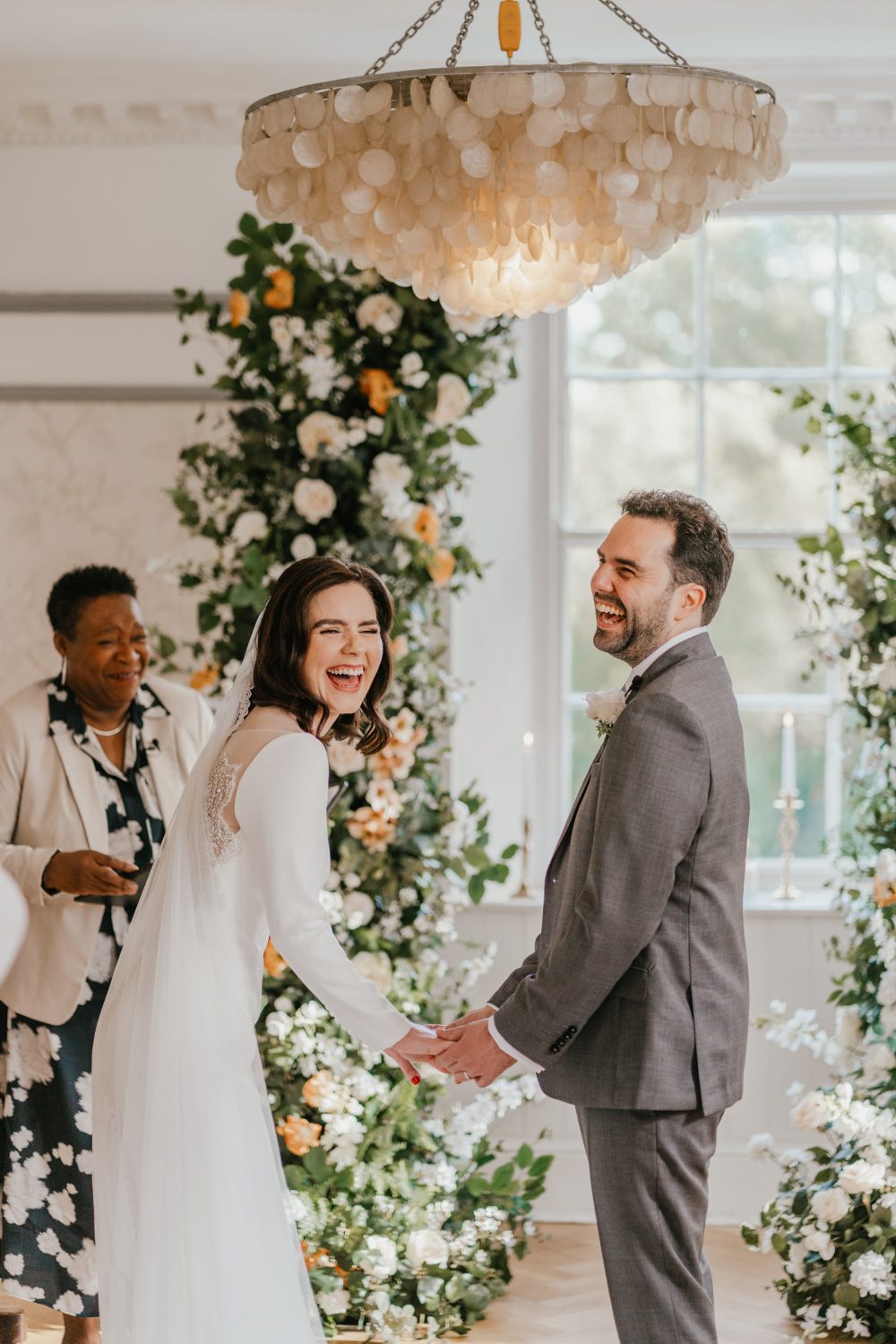 bride and groom laugh mid-ceremony at belair house wedding in london