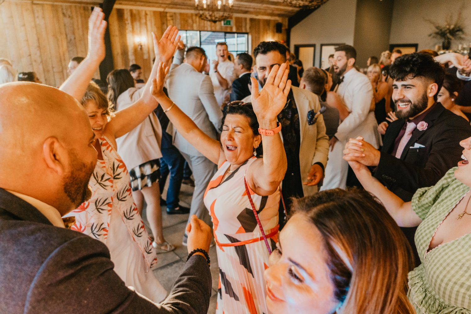 wedding guests party on the dance floor in the main barn at botley hill barn wedding