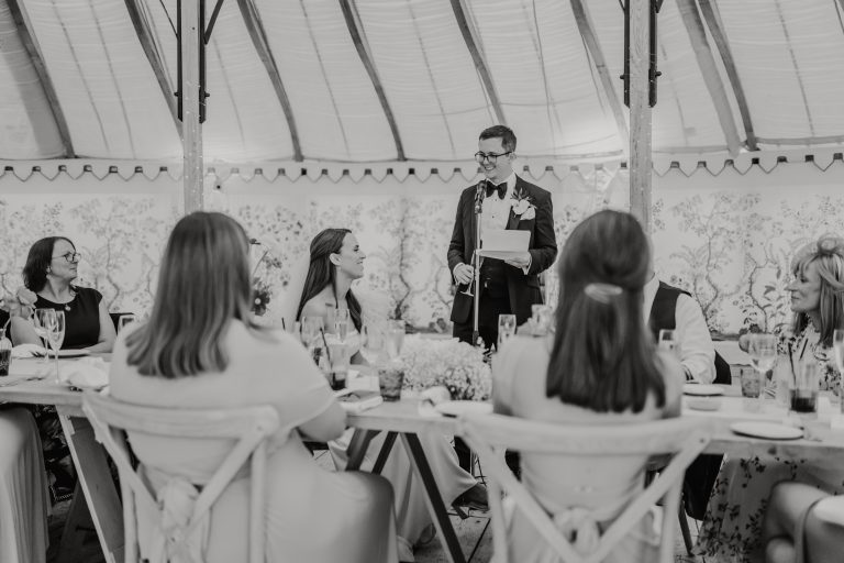 black and white photo of groom's speech in the grand pavilion at the beacon wedding