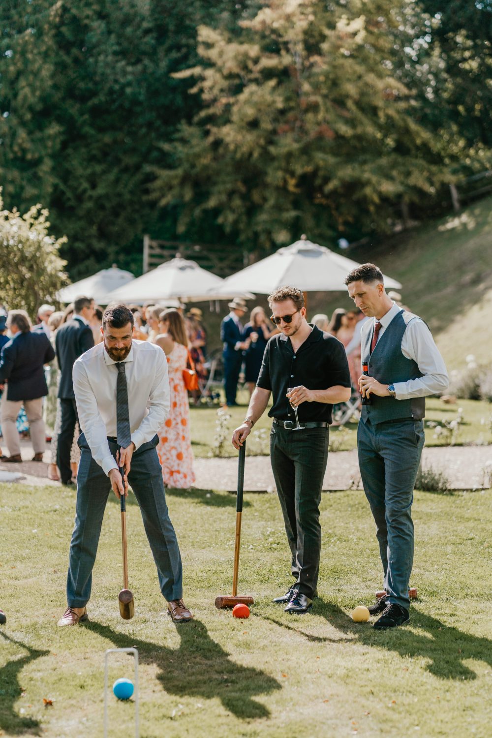group of wedding guests playing croquet on the lawn at the beacon tunbridge wells