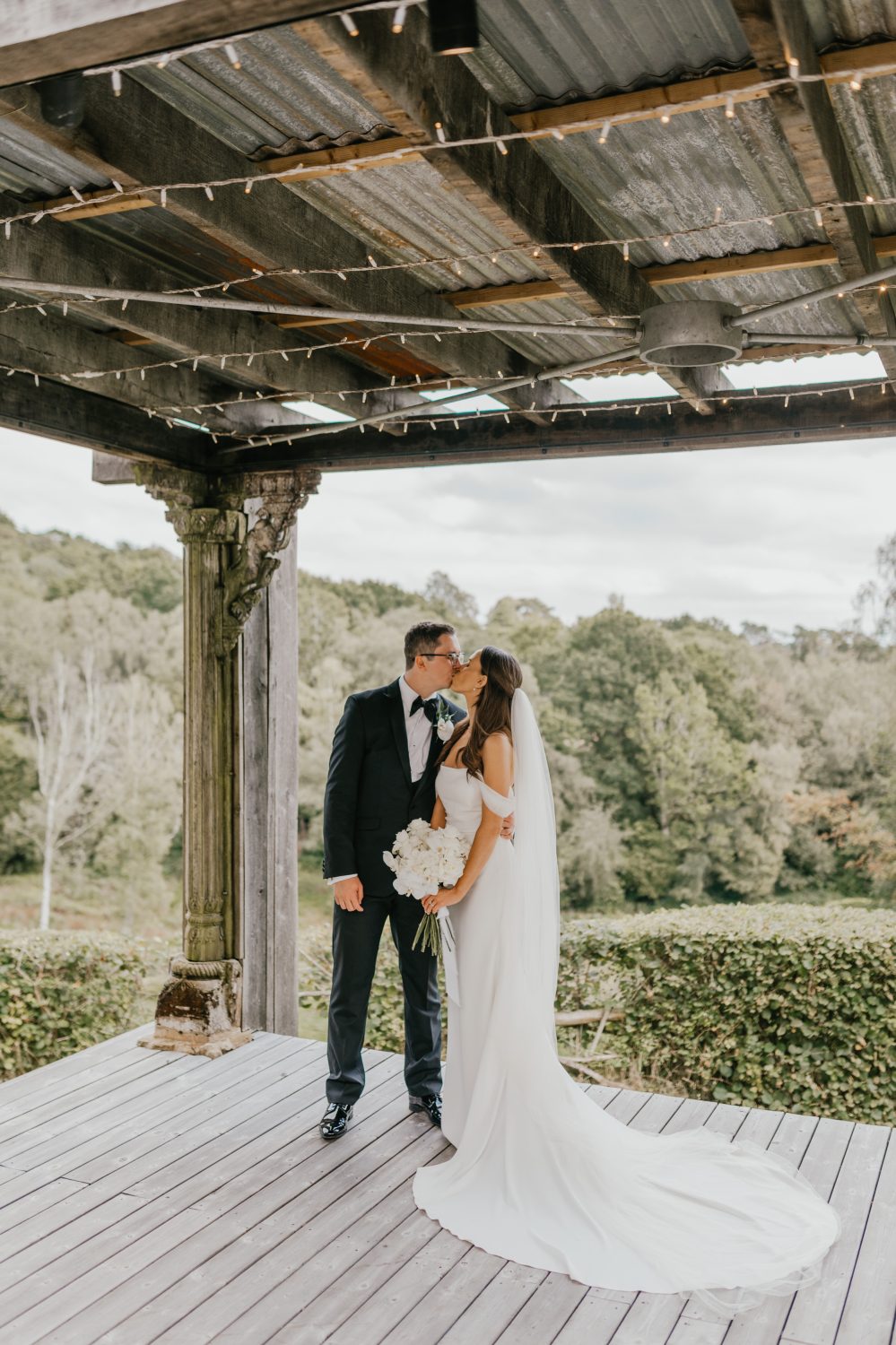 bride and groom couple portraits under the pergola at the beacon wedding venue in tunbridge wells