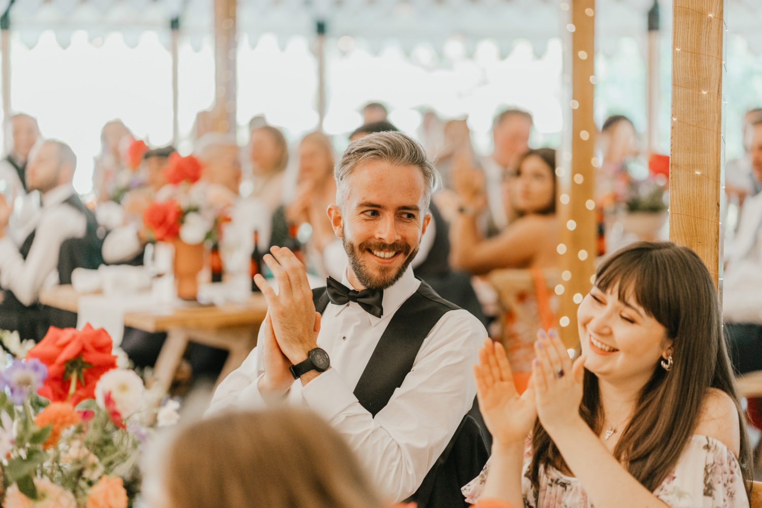 groomsman smiling at groom's speech in the grand pavilion at the beacon wedding