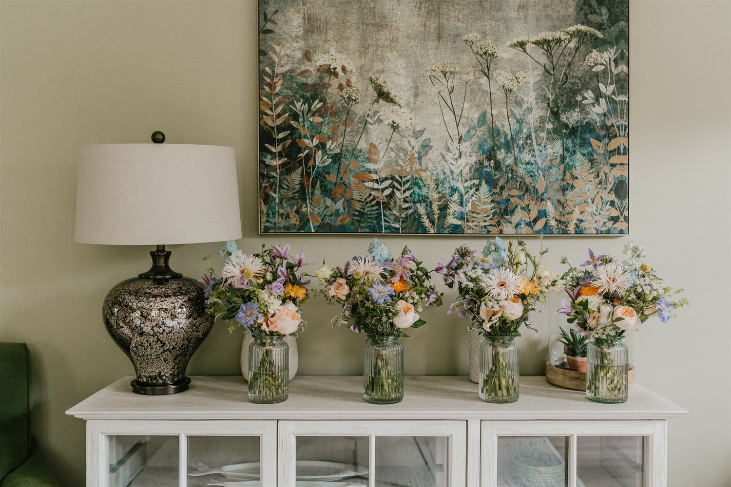 summer bridal bouquets lined up in vases