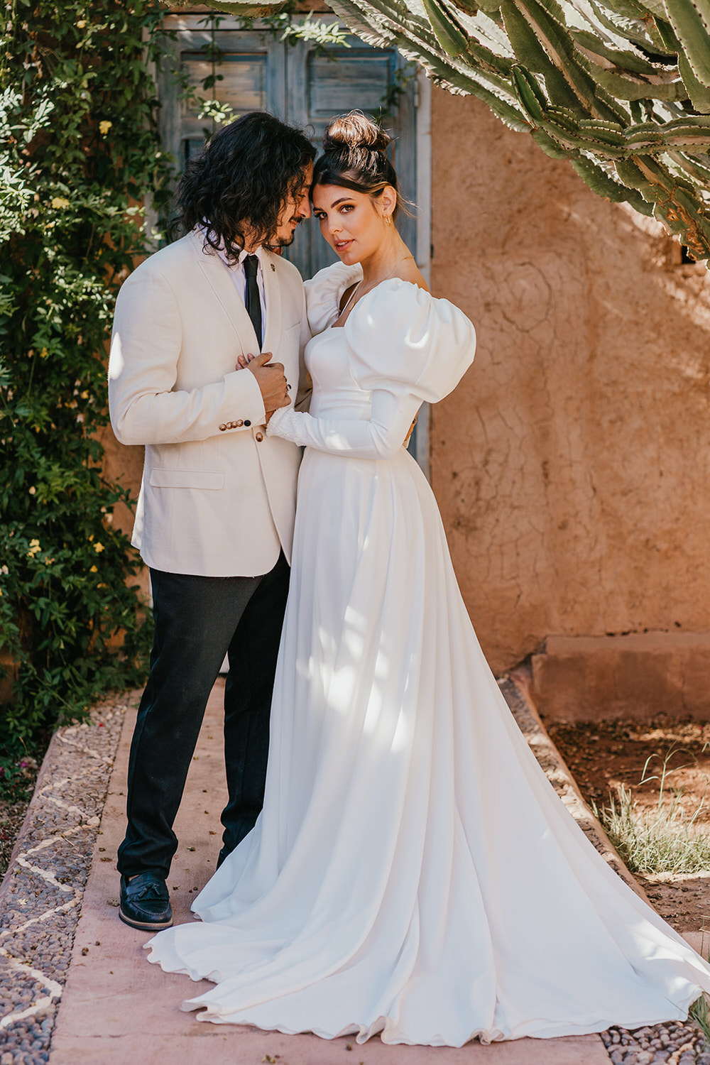 model couple pose as bride and groom at beldi country club wedding