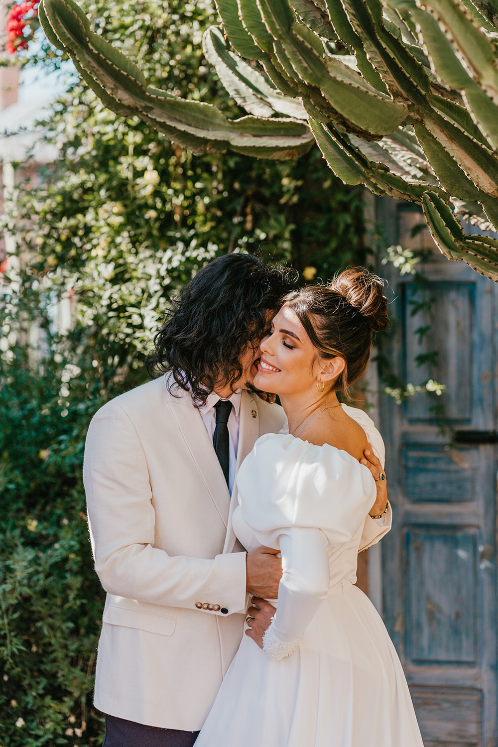 model couple pose as bride and groom at beldi country club wedding
