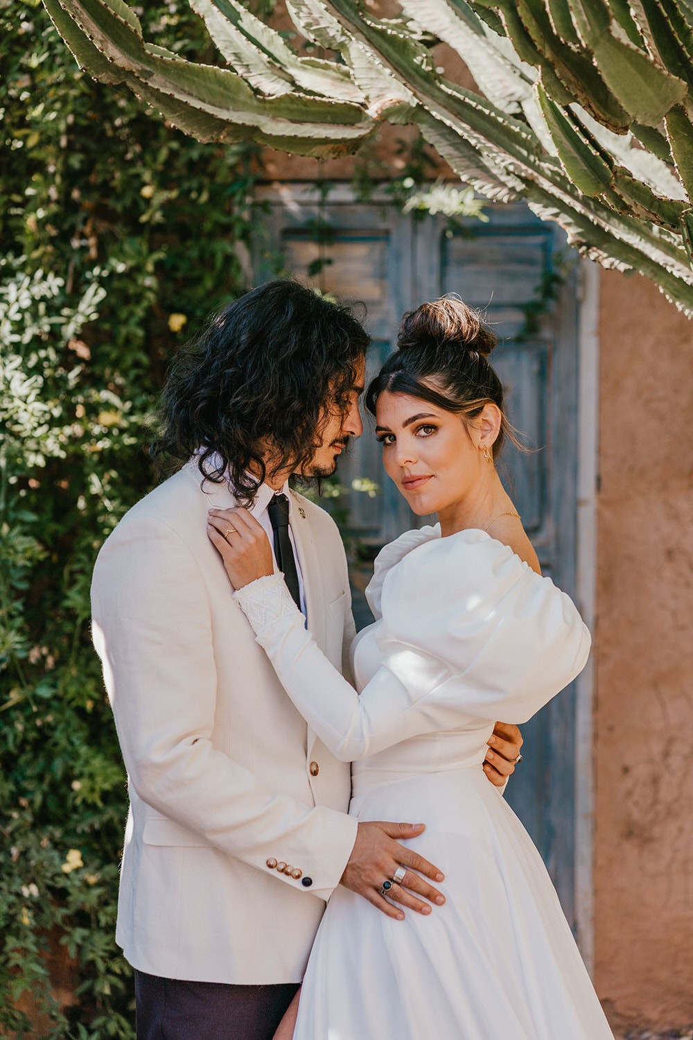 model couple pose as bride and groom at beldi country club wedding
