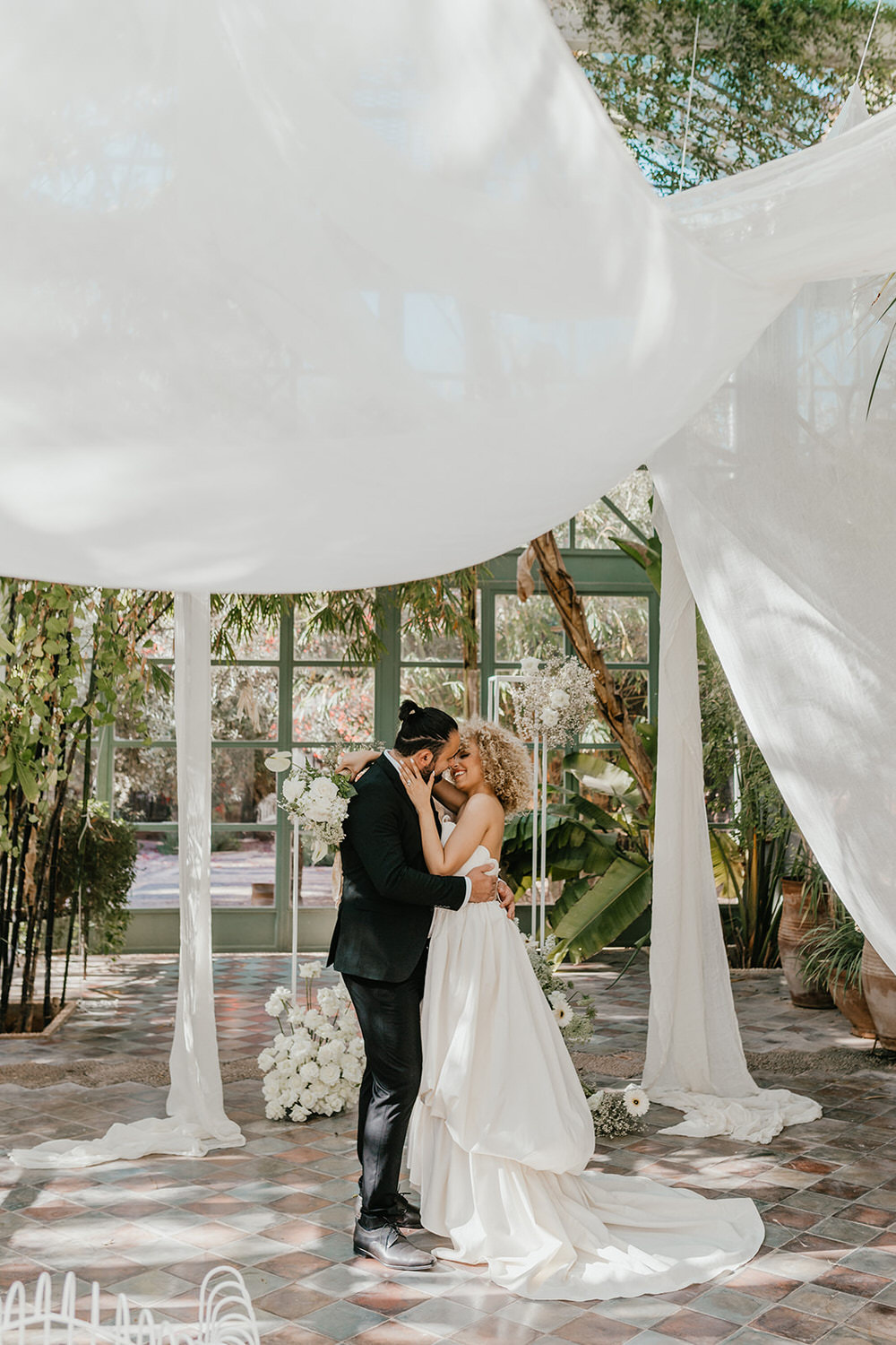bride and groom stood at the altar at beldi country club wedding ceremony