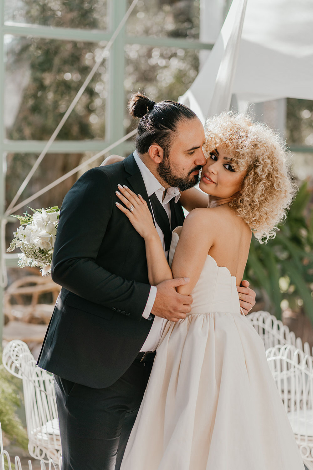bride and groom embrace in glasshouse at beldi country club in marrakech