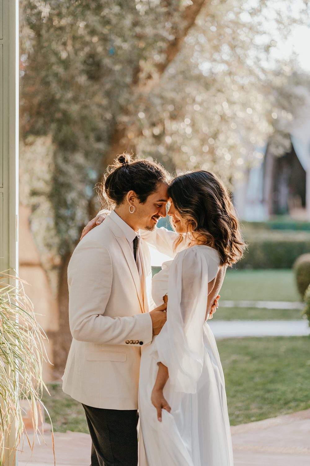 bride and groom dance in golden hour light at beldi club marrakech