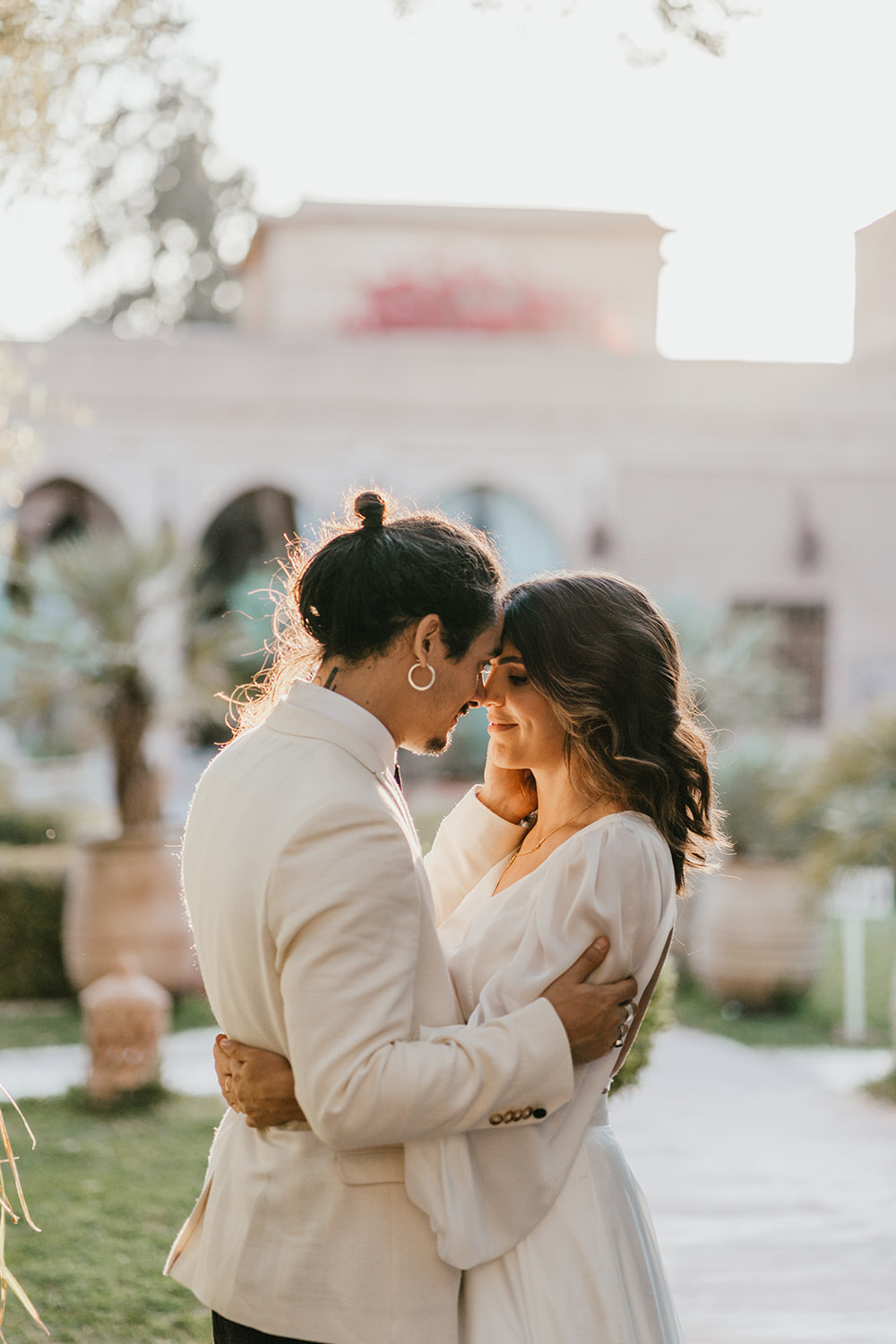 bride and groom pose in golden hour light at beldi club marrakech