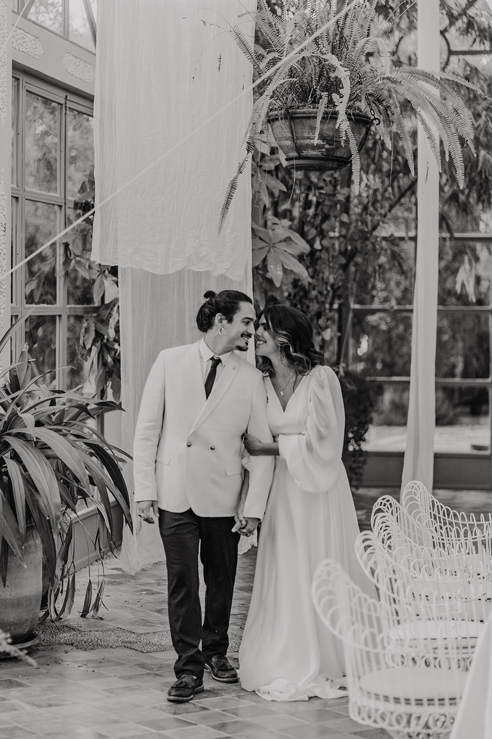 black and white photo of bride and groom in glasshouse at beldi country club wedding marrakech