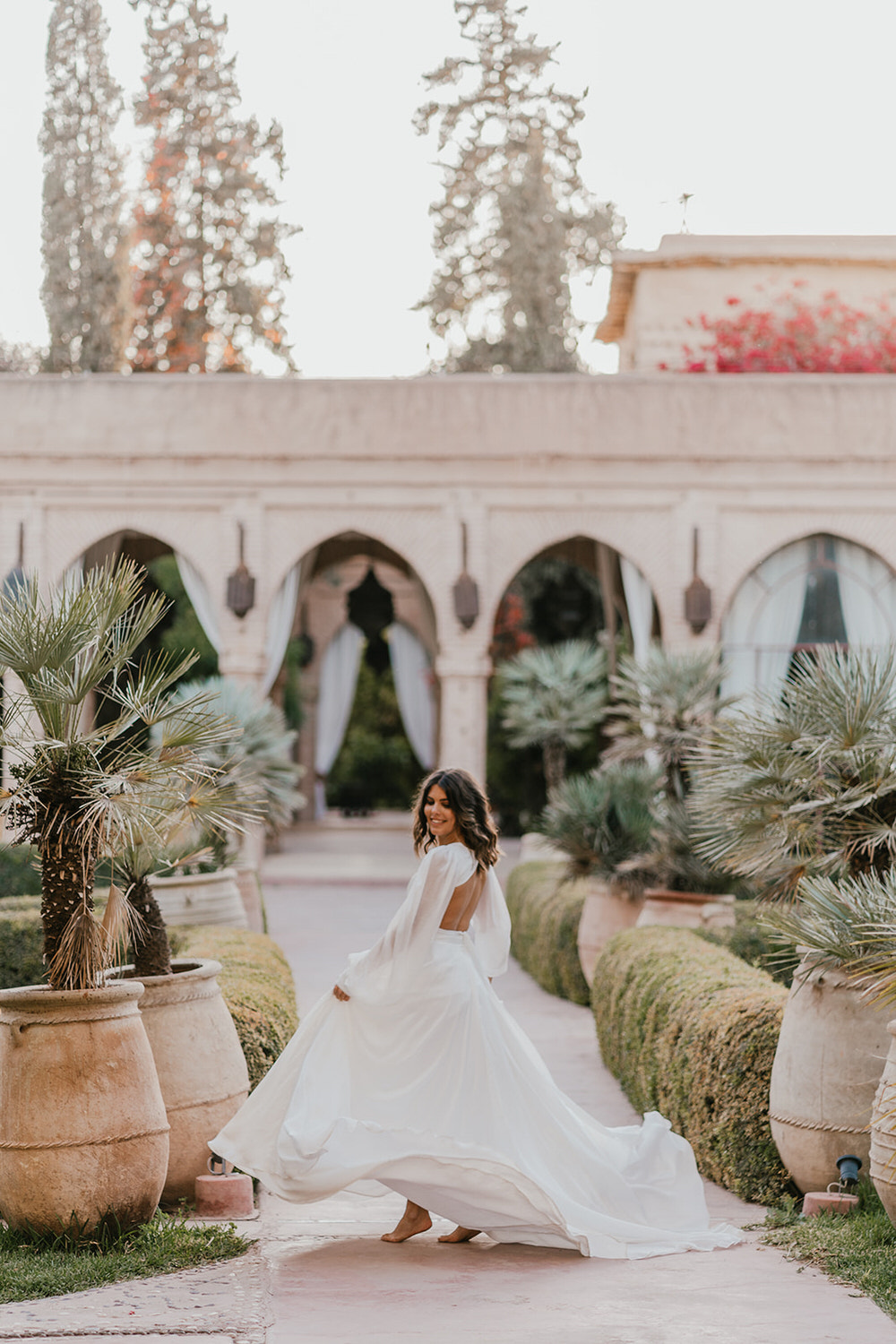 bride twirling in her wedding dress at beldi country club wedding venue in morocco
