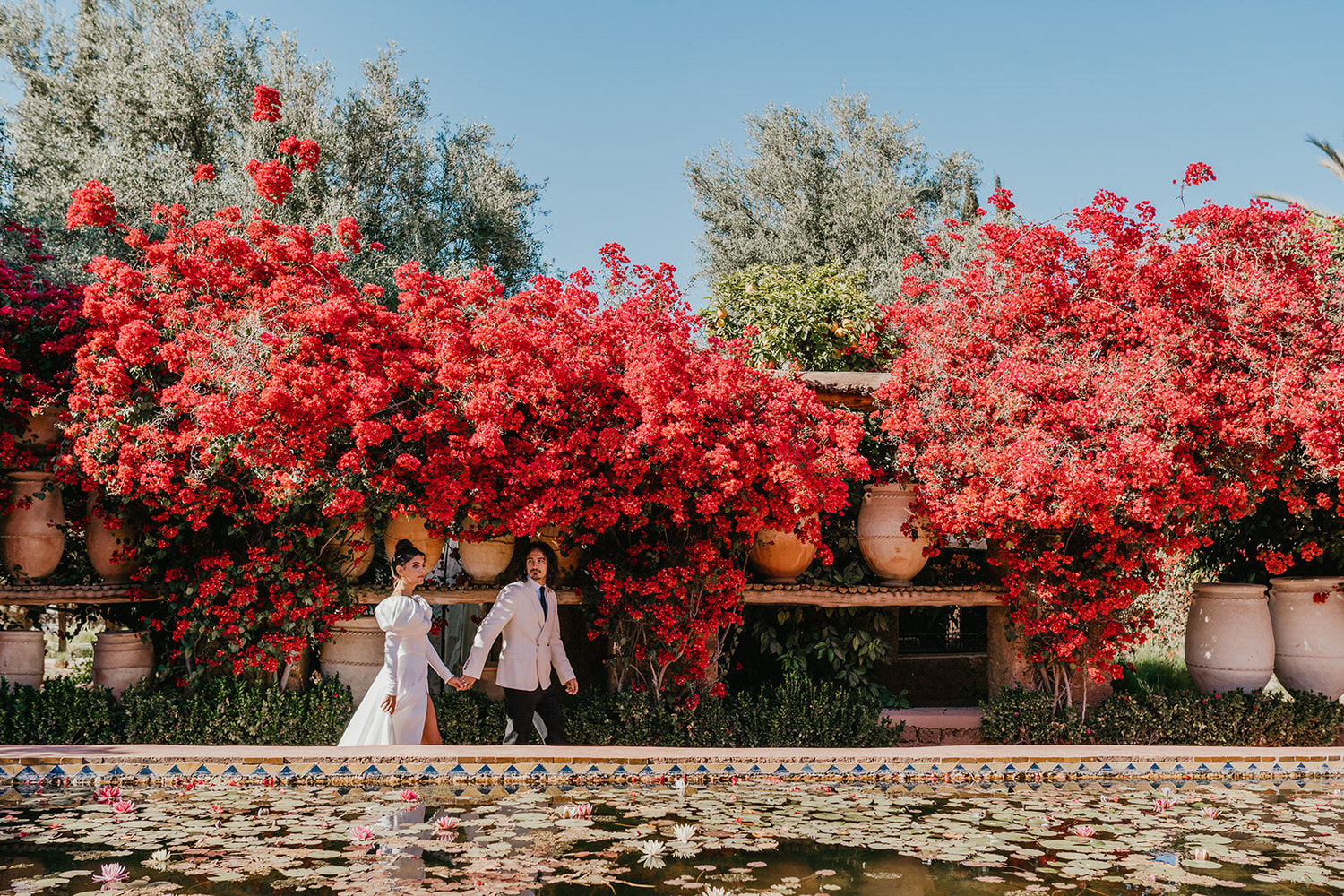 bride and groom walk through beldi country club wedding venue in marrakech