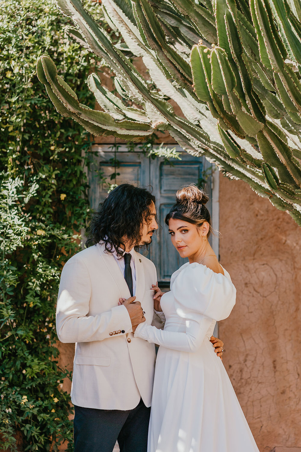 model couple pose as bride and groom at beldi country club wedding
