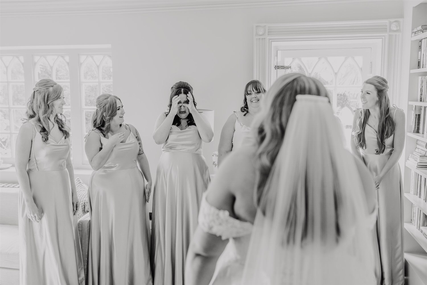 black and white photo of bride reveal to bridesmaids at chapel house estate wedding