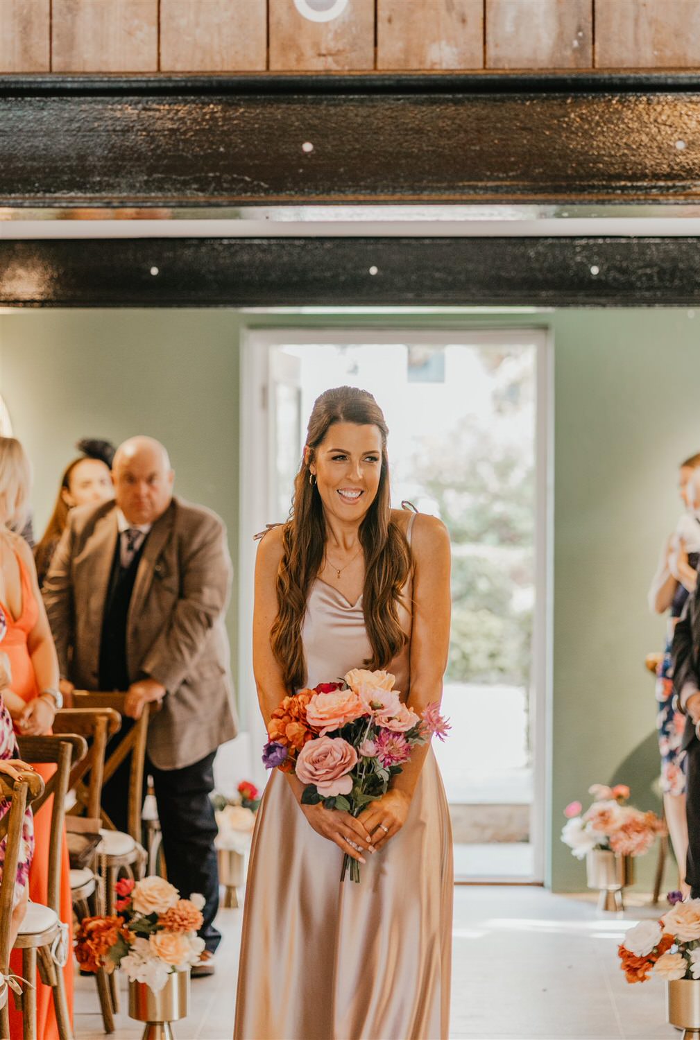 bridesmaid walking down the aisle at chapel house estate wedding