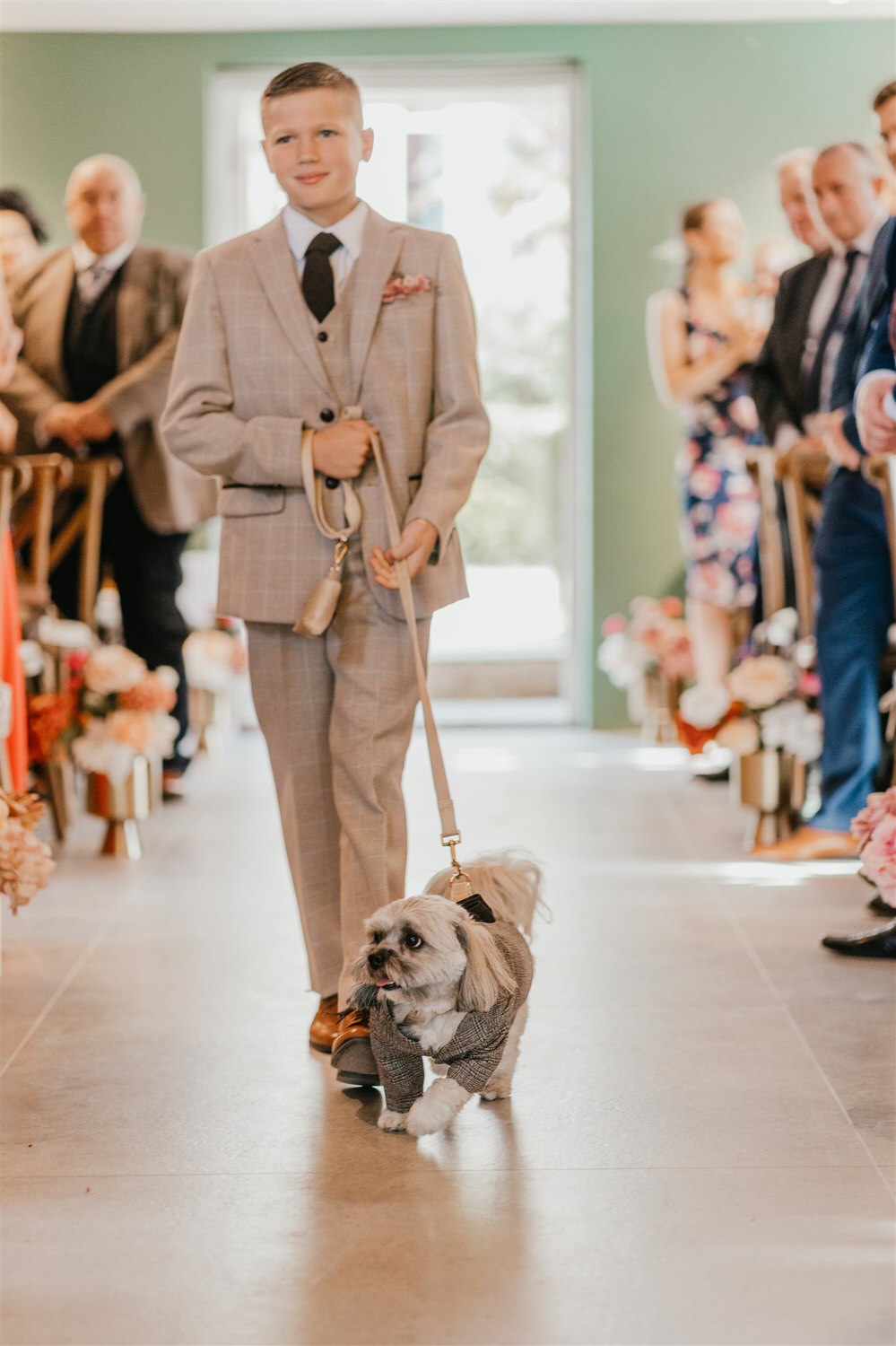 groomsman walking down the aisle with dog at chapel house estate wedding