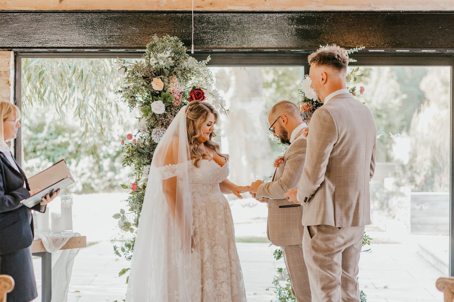 bride and groom exchange rings at chapel house estate wedding in kent