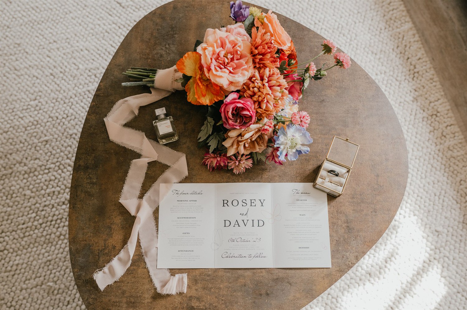 wedding details flatly with invitation, rings and flowers