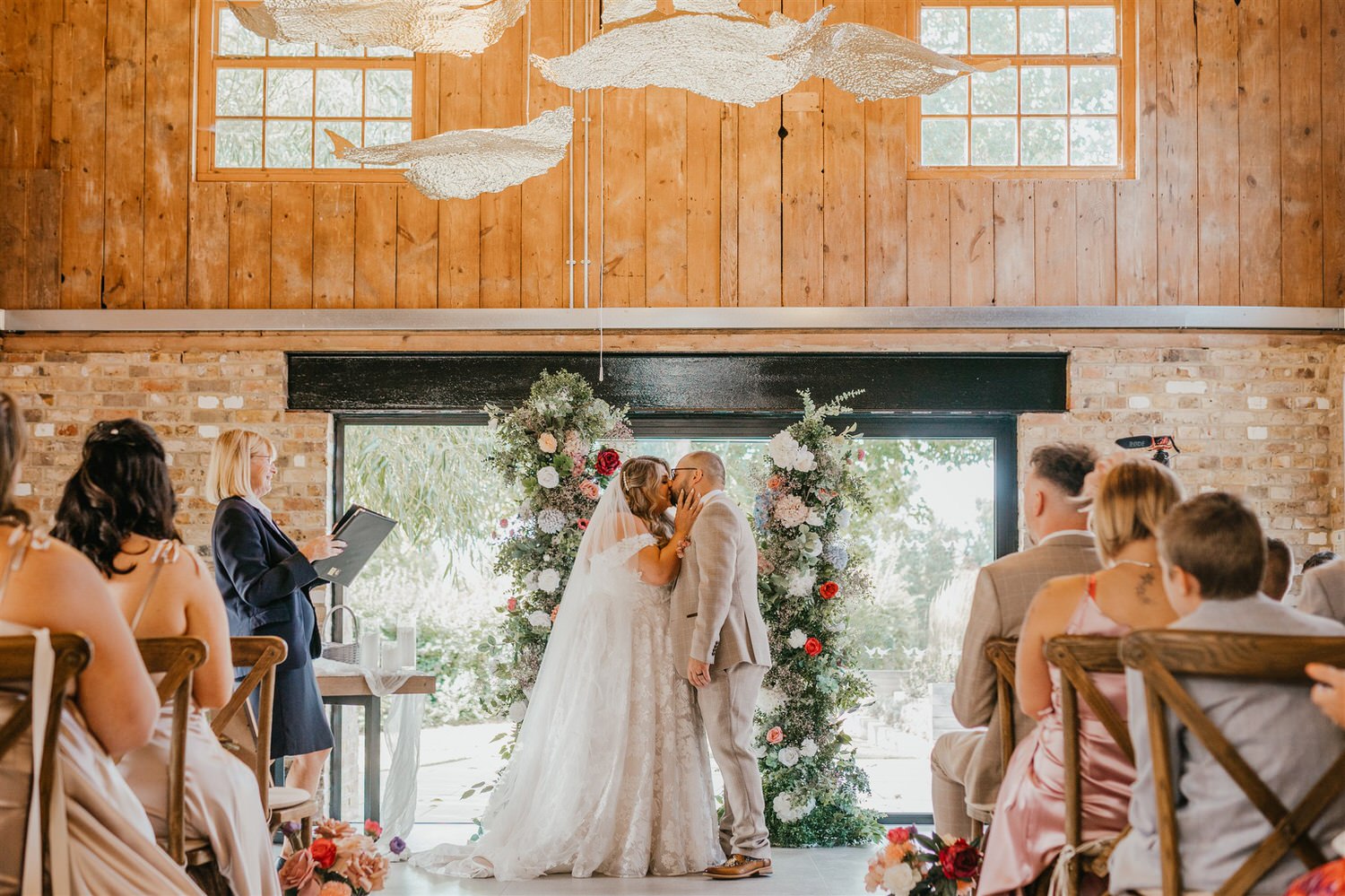 bride and groom first kiss at chapel house estate wedding in kent