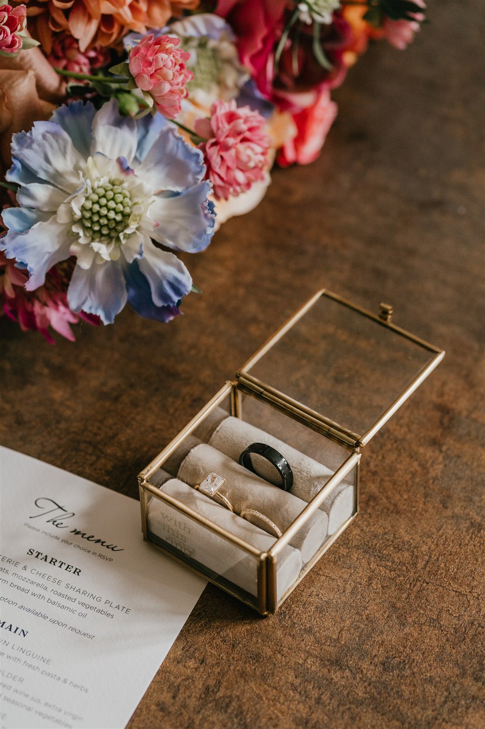 wedding details flatly with invitation, rings and flowers