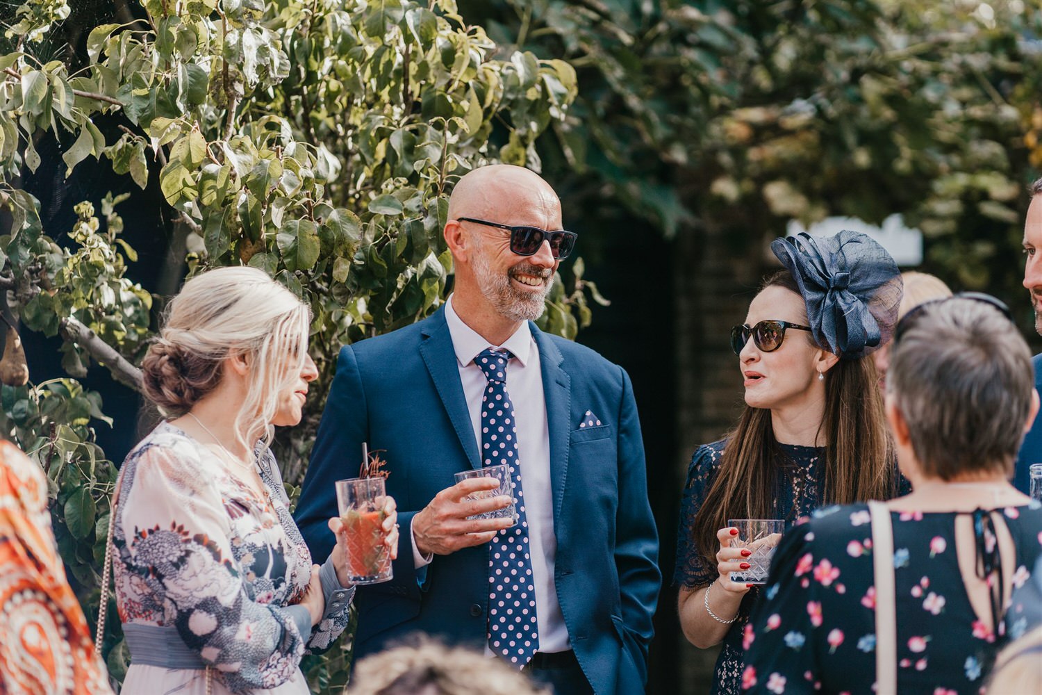drinks reception in the courtyard at chapel house estate wedding venue in kent
