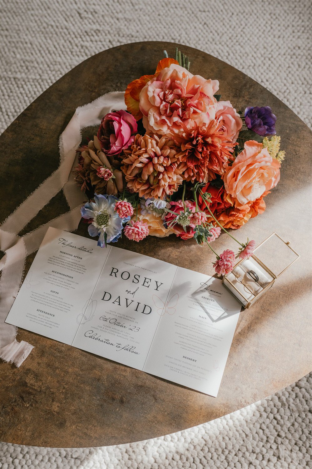 wedding details flatly with invitation, rings and flowers