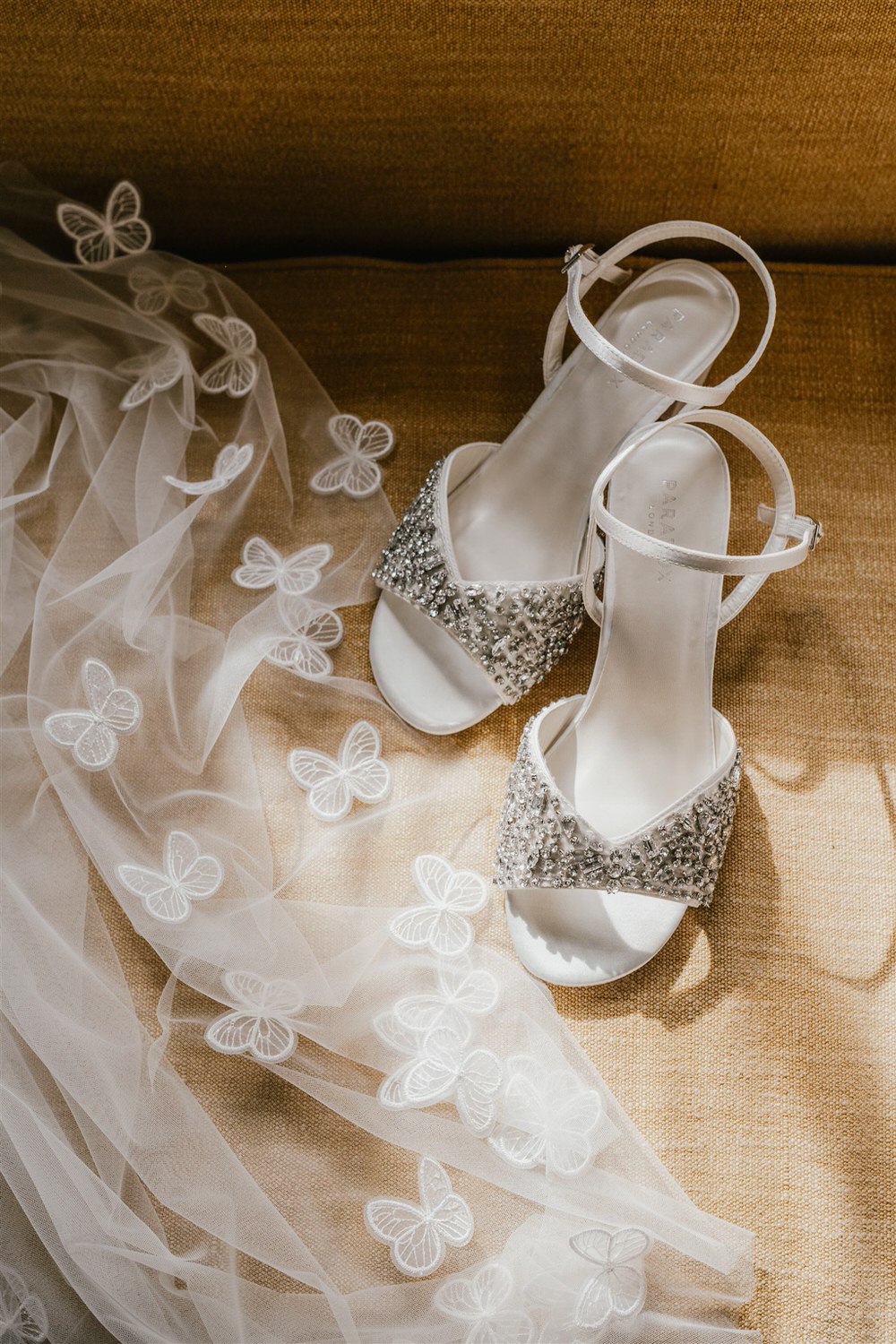 bridal wedding shoes and veil with butterfly embellishments detail shot