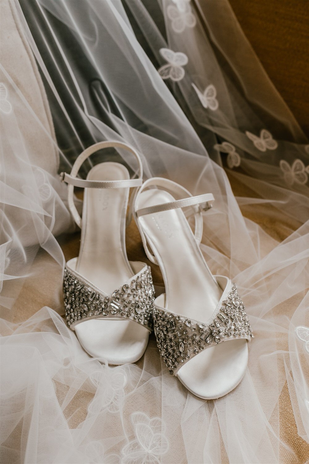 bridal wedding shoes and veil with butterfly embellishments detail shot