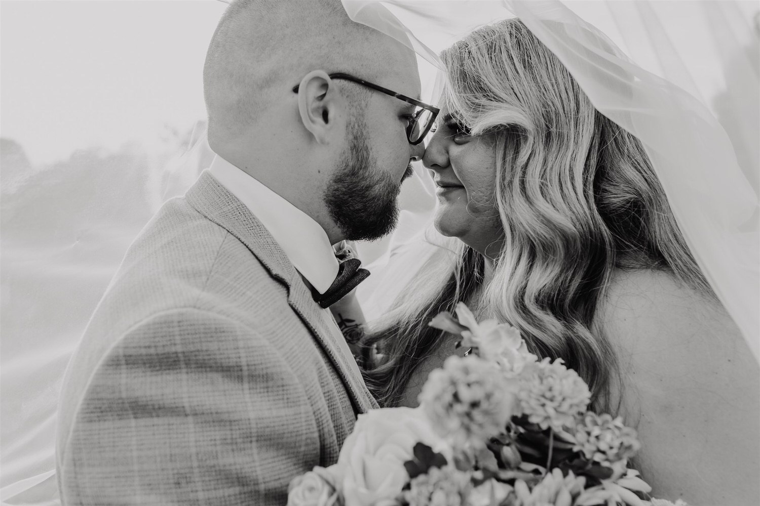 black and white photo of bride and groom sunset couple portraits with veil at chapel house estate in kent