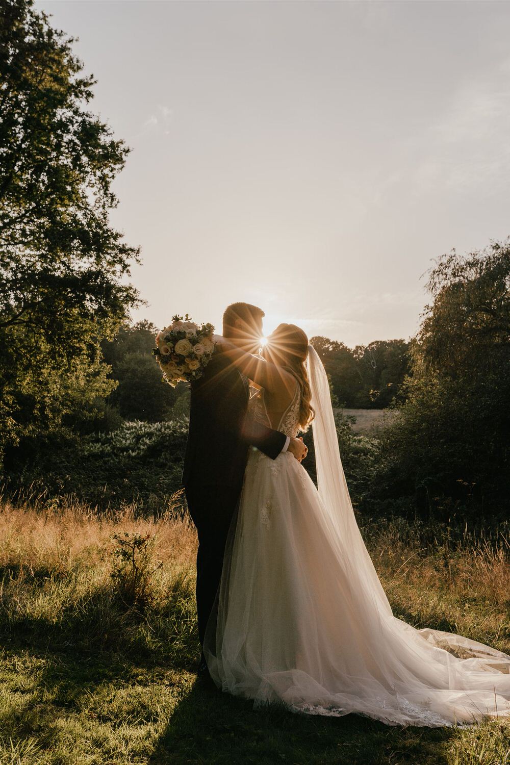 bride and groom couple portrait with sun flare at the spa hotel wedding tunbridge wells