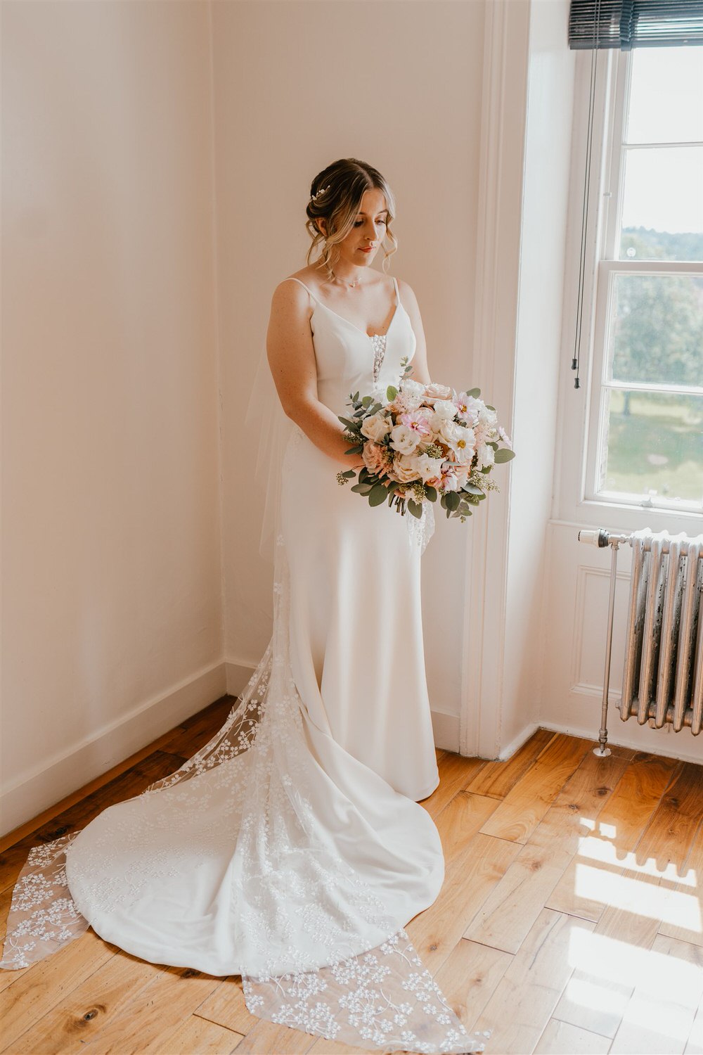 portrait of bride in her wedding dress holding bouquet