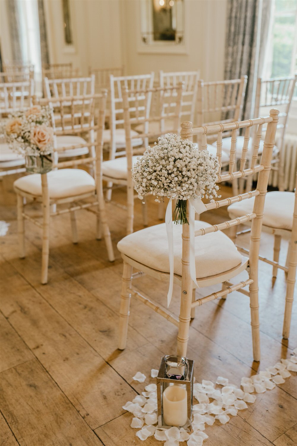 gypsophelia tied with ribbon to chair at ballroom wedding ceremony at hotel du vin tunbridge wells
