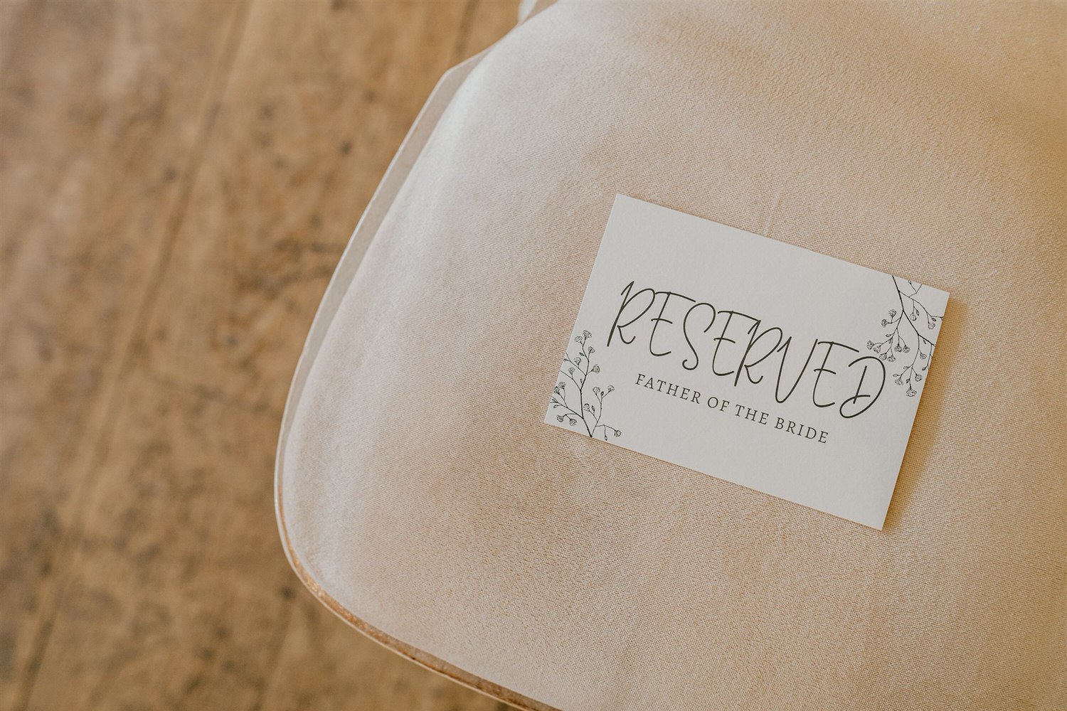 reserved for father of the bride sign on chair