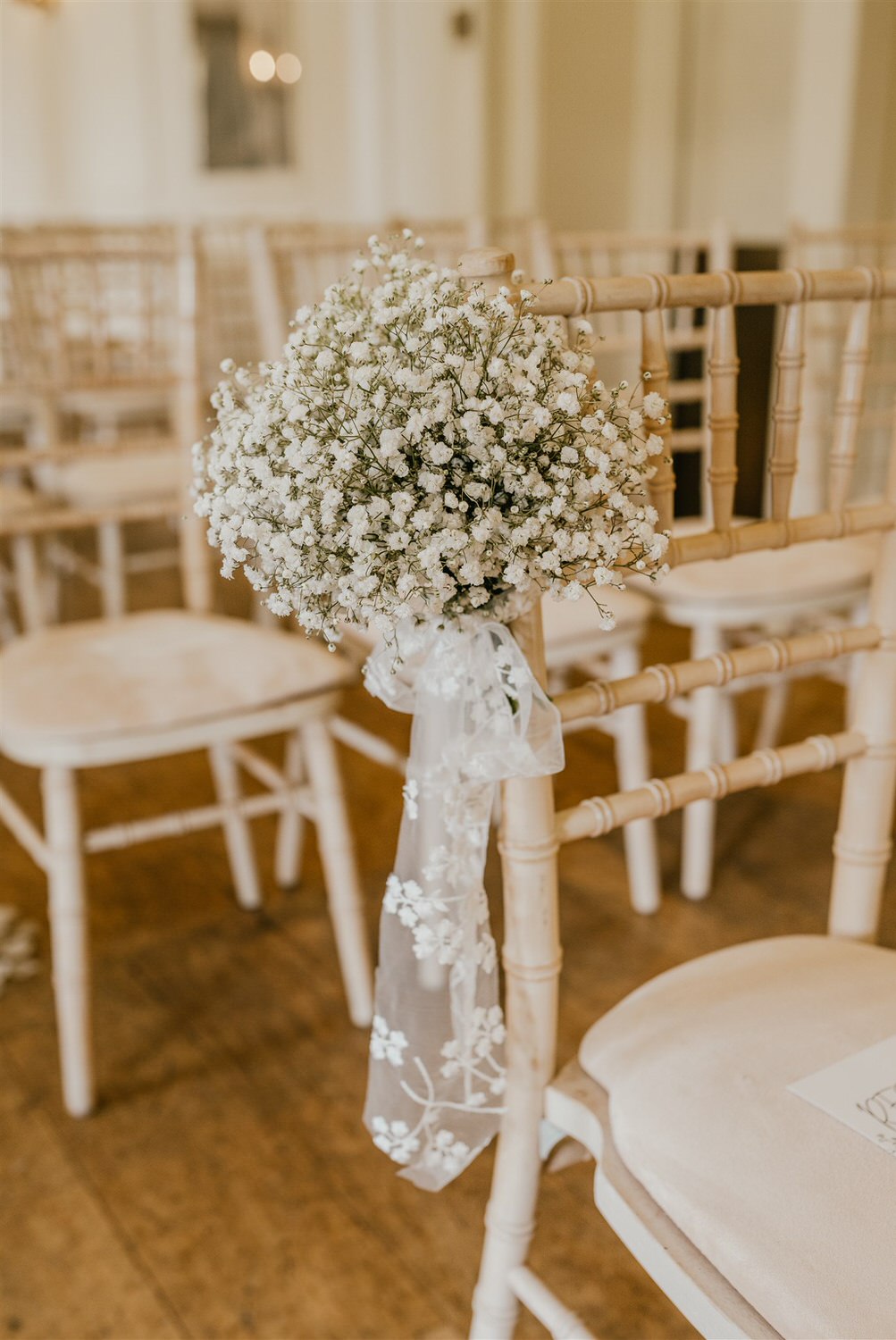 gypsophelia tied with ribbon to chair at ballroom wedding ceremony at hotel du vin tunbridge wells