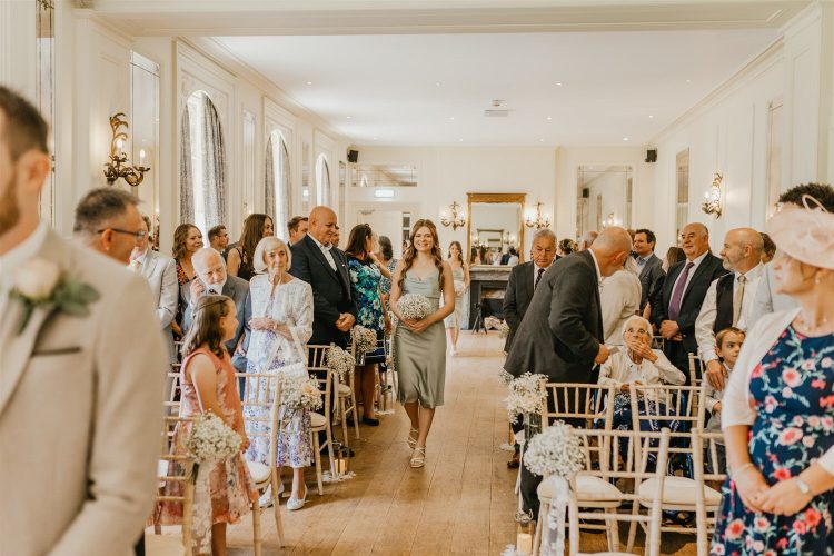 bridesmaids walking down the aisle at hotel du vin tunbridge wells wedding ceremony