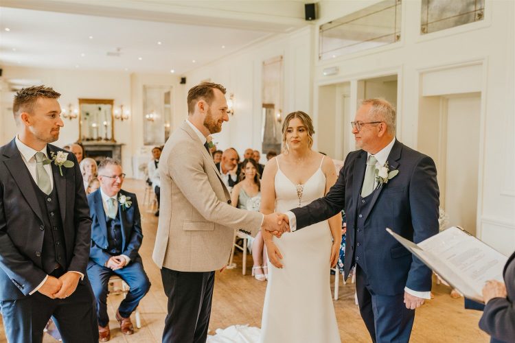 father of the bride and groom shaking hands during wedding ceremony at hotel du vin tunbridge wells